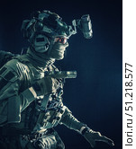 Soldier wearing combat helmet, mask and glasses, quietly sneaking darkness with handgun in hand. Oleg Zabielin / Stocktrek Images/TASS. Стоковое фото, агентство ТАСС / Фотобанк Лори