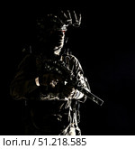 Special forces soldier equipped with night vision device and submachine gun with silencer, looking away. Oleg Zabielin / Stocktrek Images/TASS. Стоковое фото, агентство ТАСС / Фотобанк Лори