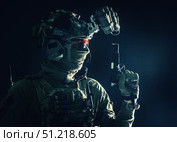 Studio portrait of soldier wearing a mask, helmet with night vision device, and armed with service pistol. Oleg Zabielin / Stocktrek Images/TASS. Стоковое фото, агентство ТАСС / Фотобанк Лори