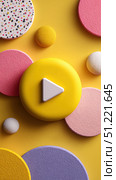 White play symbol centered in yellow circle, surrounded by multicolored spheres representing dynamic media design with vibrant visual energy. Стоковое AI-изображение, AI-художник Юрий Поздников / Фотобанк Лори