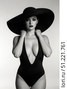 Beautiful fashion model in swimsuit and hat posing on studio background, black and white. Стоковое AI-изображение, AI-художник Станислав Тарко / Фотобанк Лори