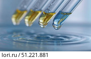 Laboratory pipettes releasing vibrant liquid droplets, creating rippling concentric patterns with scientific precision across reflective water surface. Стоковое AI-видео, аниматор Юрий Поздников / Фотобанк Лори
