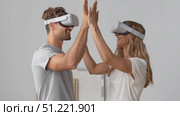 Couple wearing virtual reality headsets, interacting enthusiastically while gesturing wildly, experiencing immersive digital world and cutting edge technological interaction. Стоковое AI-видео, аниматор Юрий Поздников / Фотобанк Лори