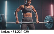 Powerful young woman performing deadlifts with heavy barbell, showcasing strength and determination in a modern fitness center illuminated by vibrant neon lights. Стоковое AI-видео, аниматор Юрий Поздников / Фотобанк Лори
