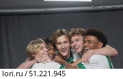 Diverse soccer teammates embracing, celebrating championship win with intense emotion, displaying united team spirit in locker room after intense match. Стоковое AI-видео, аниматор Юрий Поздников / Фотобанк Лори