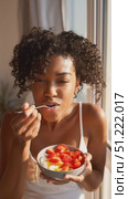 Soft morning sunlight highlighting woman enjoying yogurt bowl with ripe strawberries, embodying peaceful breakfast moment. Стоковое AI-видео, аниматор Юрий Поздников / Фотобанк Лори