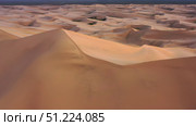 Aerial view of sand dunes in desert at sunset. Стоковое фото, фотограф Михаил Коханчиков / Фотобанк Лори