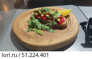 Sandwich with meat, herbs and avocado on a wooden stand in the restaurant. Стоковое видео, видеограф worker / Фотобанк Лори