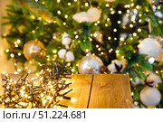 Wooden shelf against background of New Year glowing garland on Christmas tree. Стоковое фото, фотограф Aleksandra Selivanova / Фотобанк Лори