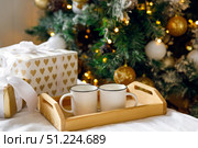 Wooden tray and two white mugs on bed on white sheet. Стоковое фото, фотограф Aleksandra Selivanova / Фотобанк Лори