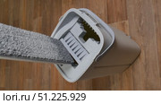 Modern mop is wrung out from water in gray bucket for washing floors on brown floor, cleaning concept household chores. Стоковое видео, видеограф Катерина Белякина / Фотобанк Лори
