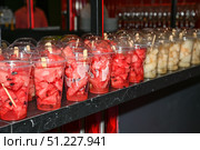 Cups filled with fresh watermelon and melon pieces served as vegan snacks on a party table, ready for guests as healthy summer refreshments. Стоковое фото, фотограф Татьяна Терехина / Фотобанк Лори