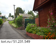 Yuryevets, Ivanovo region, Russia, July 24, 2025: View of Engels Lane on way to 18th century Epiphany Church. Редакционное фото, фотограф Алексей Антипов / Фотобанк Лори