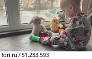A Child Engaged in Play with Soft Plush Toys in a Warm and Cozy Setting for Comfort. Стоковое видео, видеограф Olesia Kondrateva / Фотобанк Лори