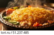 Steaming hot saffron rice with vegetables and meat in a clay pot. Стоковое фото, фотограф David Kashakhi / Фотобанк Лори