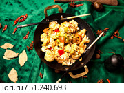 Stir-fried Cauliflower Delight in a Wok, Oriental Spices on a Green Velvet. Стоковое фото, фотограф Aleksandr Golubev / Фотобанк Лори