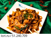 A Tempting Serving of Delicious Chinese Cuisine on Green Silk. Стоковое фото, фотограф Aleksandr Golubev / Фотобанк Лори