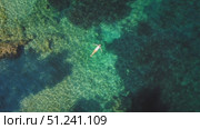 Woman floating in crystal clear shallow sea water near a rocky reef in Kefalonia. Стоковое видео, видеограф Ольга Сухарева / Фотобанк Лори