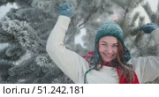 Woman Laughing and Playing in Fresh Winter Snow Next to Decorated Christmas Tree. Стоковое видео, видеограф Ольга Коваленко / Фотобанк Лори