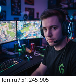 Newfangled Profession gamer - portrait of a young calm guy at a computer desk. AI generated. Стоковое AI-изображение, AI-художник Андрей Аркуша / Фотобанк Лори