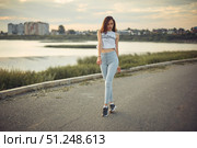 Young beautiful caucasian blonde girl listening to music with smartphone walking and dance in the city with headphones smiling - relax, youth, emancipation concept. Стоковое фото, фотограф Арзюков Вадим Николаевич / Фотобанк Лори
