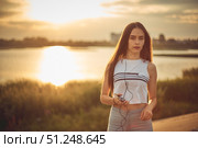 Young beautiful caucasian girl listening to music with smartphone walking in the city with headphones smiling - relax, youth, emancipation concept. Стоковое фото, фотограф Арзюков Вадим Николаевич / Фотобанк Лори