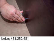 Close-up of men's hands tightening a furniture screw with a hex key. Стоковое фото, фотограф Екатерина Кузнецова / Фотобанк Лори