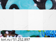 colorful urban wall with four wrinkled glued poster templates. Стоковое фото, фотограф Александра Конопля / Фотобанк Лори