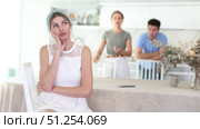 Portrait of upset offended woman sitting in home kitchen on background of discontented daughter and son standing behind. Family conflicts and communication problems concept. Стоковое видео, видеограф Яков Филимонов / Фотобанк Лори