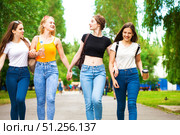 Four happy schoolgirls walking in summer park. Стоковое фото, фотограф Андрей Аркуша / Фотобанк Лори