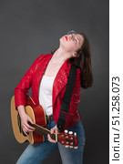 Female guitarist adopts posture with head thrown back, and she performs soulful rendition on guitar. Стоковое фото, фотограф А. А. Пирагис / Фотобанк Лори