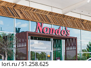 Nando's Restaurant Storefront with Red Logo Signage. London, UK, 28 July 2024. Редакционное фото, фотограф Zydrius Tartenis / Фотобанк Лори