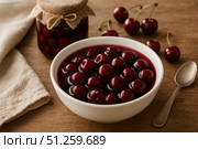 Deliciously Captivating Cherry Compote Served in a Bowl Alongside Fresh Cherries and a Spoon, Perfect for Desserts or Toppings. Стоковое AI-изображение, AI-художник Башкирова Анна / Фотобанк Лори