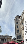 Galata Tower in Istanbul, view from the narrow street Narrow street with Galata Tower and historic building in Beyoglu district, Istanbul, Turkey Beautiful view of city street with different stores. Редакционное фото, фотограф Zita Khasanova / Фотобанк Лори