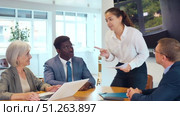 Business men and woman engaged in conversation sitting around table in conference room. Стоковое видео, видеограф Яков Филимонов / Фотобанк Лори