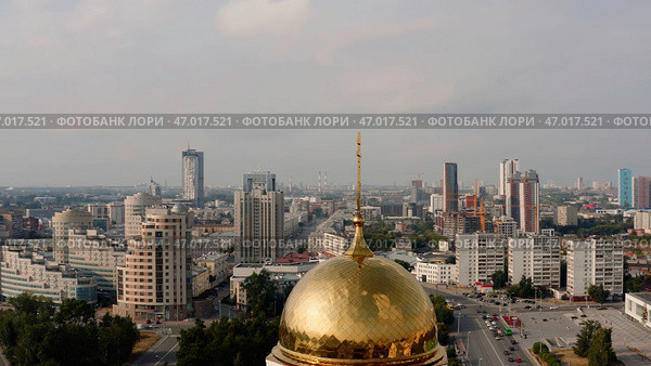 A beautiful landscape with tall houses and offices, a temple and parks with a bright sun. Стоковое фото, фотограф David Kashakhi / Фотобанк Лори