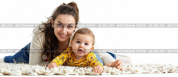A beautiful young mother and her little son are lying on the floor on a white background and looking at the camera. The concept of maternal happiness. Стоковое AI-изображение, AI-художник Ярославский Максим / Фотобанк Лори