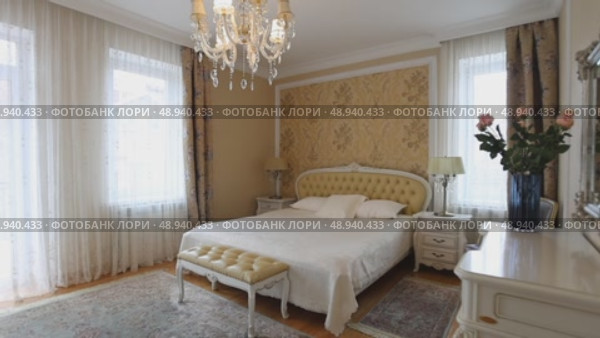 A beautifully designed bedroom with a large bed and stylish furniture. Стоковое видео, видеограф Cantemir Dumitru / Фотобанк Лори