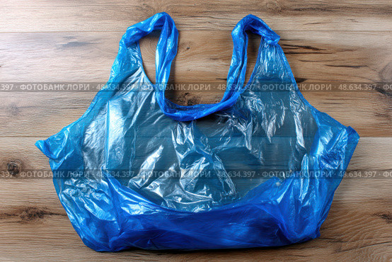 A blue plastic bag is on a wooden surface. Стоковое AI-изображение, AI-художник Ярославский Максим / Фотобанк Лори