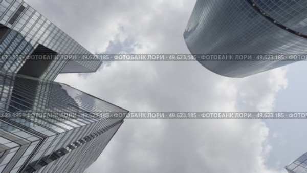 A city skyline with a cloudy sky and tall buildings. Стоковое видео, видеограф Ярославский Максим / Фотобанк Лори
