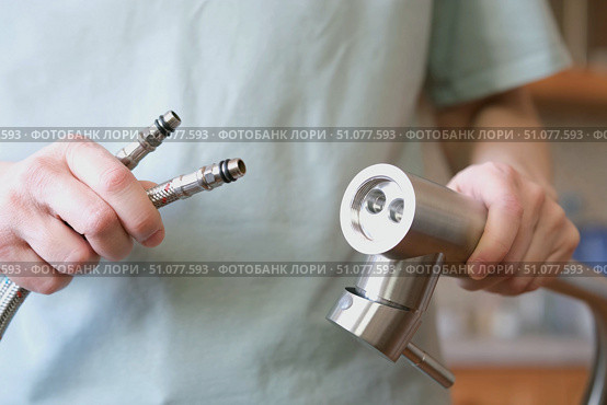 A close-up of a mixer with flexible hoses for cold and hot water installed. Стоковое фото, фотограф Ветерцовская Галина Валериевна / Фотобанк Лори