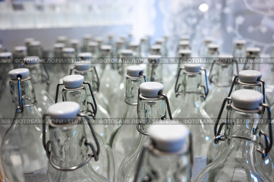 A closeup of the neck of a bottle. Group of empty bottles with plastic caps in a store on the counter. Стоковое фото, фотограф Михаил Решетников / Фотобанк Лори