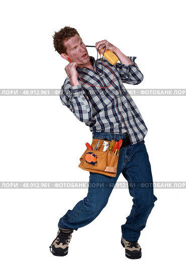 A dazed electrician suffering from electric shock. Стоковое фото, агентство Ingram Publishing / Фотобанк Лори