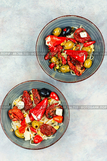A delicious salad of pickled soybean sprouts, dried tomatoes, olives and peppers. Chinese food. Top view.. Vegan Salad of Pickled Vegetables and Soybeans. Стоковое фото, агентство Ingram Publishing / Фотобанк Лори