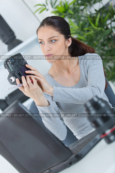 a female photographer checking camera. Стоковое фото, агентство Ingram Publishing / Фотобанк Лори