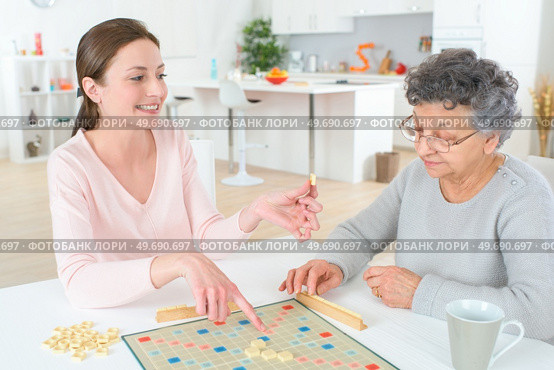 a game of scrabble with an old woman. Редакционное фото, агентство Ingram Publishing / Фотобанк Лори