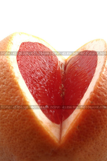 A large grapefruit with a cut-out part on a white background. Side view. Isolated. Стоковое фото, фотограф Ярославский Максим / Фотобанк Лори