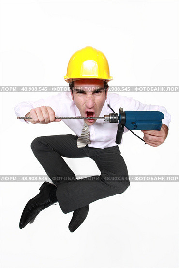 A mad architect biting a drill. Стоковое фото, агентство Ingram Publishing / Фотобанк Лори