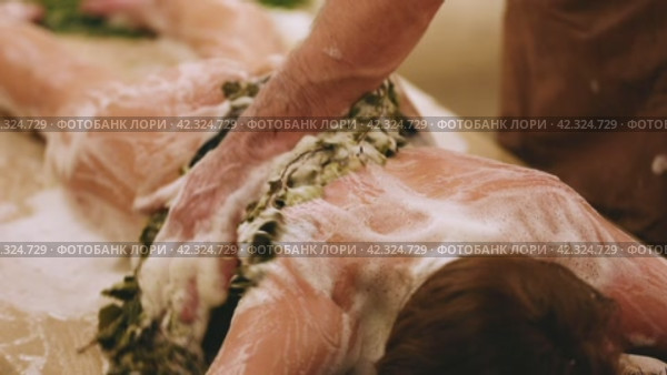 A male bathhouse attendant does a foam procedure to a woman in a hammam. Стоковое видео, видеограф Юрий Поздников / Фотобанк Лори