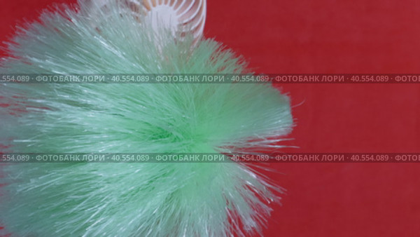 A man demonstrating the power of the airflow of a portable fan. Installs the brush and blows it from different sides. On a coral background. Close-up. Стоковое видео, видеограф Vadzim Yakubovich / Фотобанк Лори